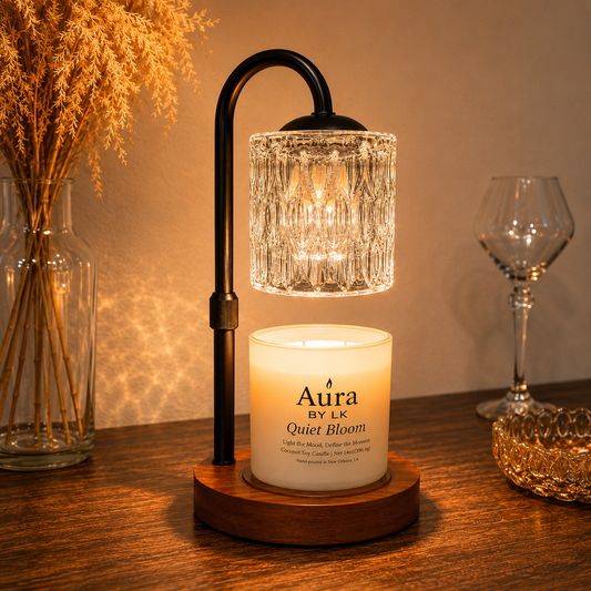 Aura By LK candle warmer lamp with a black stand and glass shade warming a Quiet Bloom candle.
