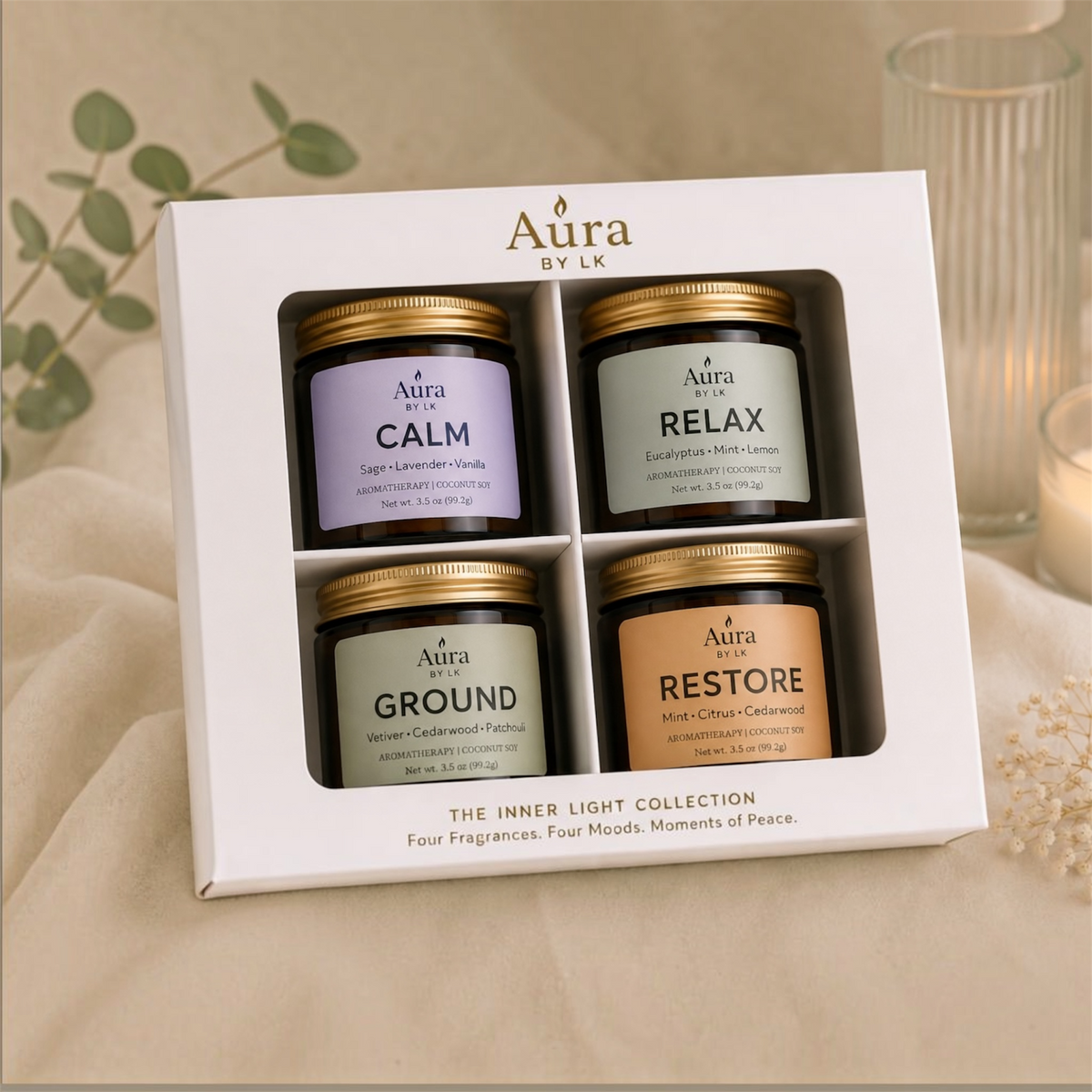 Aura By LK Inner Light Discovery Set with four candles—CALM, RELAX, GROUND, and RESTORE—arranged in a white gift box.